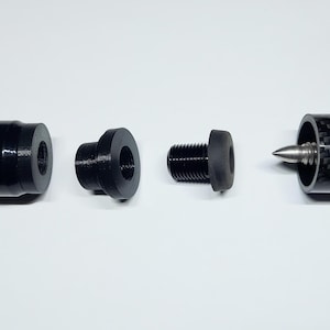 May include: A disassembled pool cue with a black and carbon fiber shaft, a wooden butt with a red stripe, and a black joint. The cue is designed to be taken apart for storage or transport.