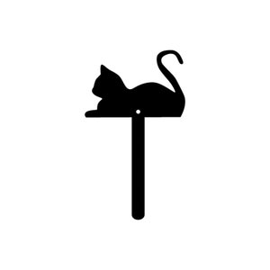 May include: Black metal silhouette of a cat curled up on a pole. The cat is facing left and has a long tail.
