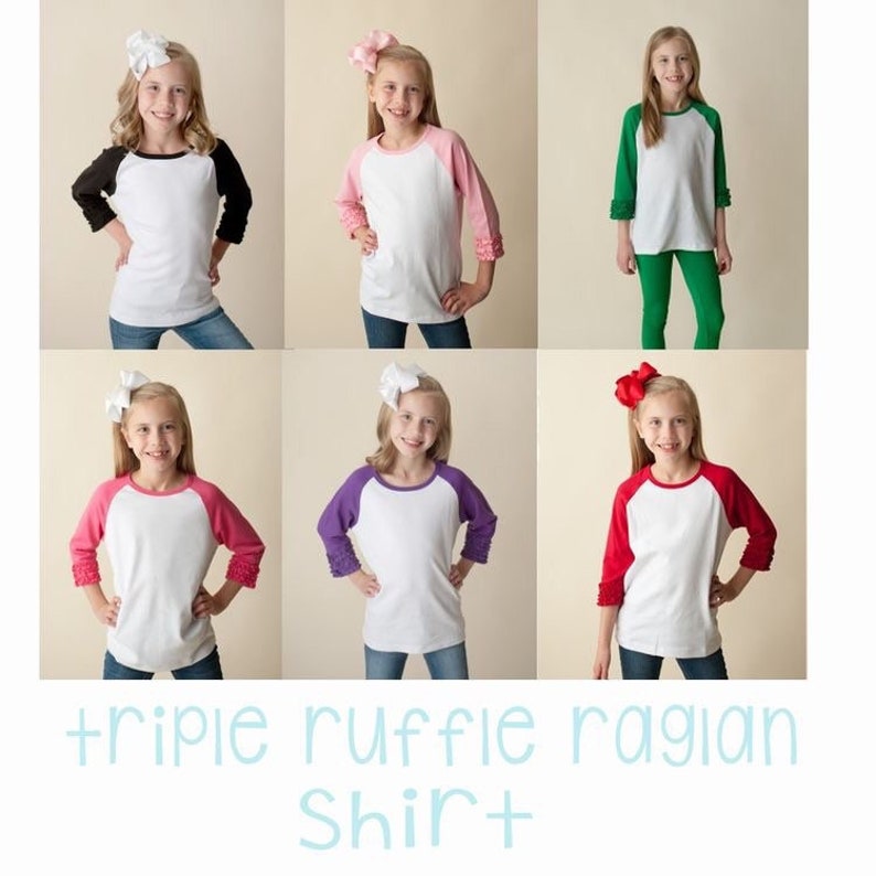 May include: Six girls wearing white long-sleeved shirts with different coloured raglan sleeves. The shirts have triple ruffles on the sleeves. The text "triple ruffle raglan shirt" is at the bottom of the image.