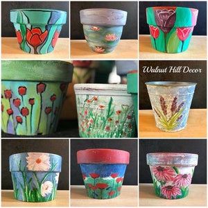 Maceta pintada a mano: girasol, amapola y rosa.