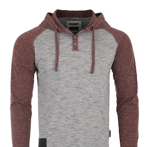 May include: A long-sleeved hooded shirt with a button-up placket. The shirt is a two-tone color scheme with a gray and burgundy color combination. The shirt has a raglan sleeve design.