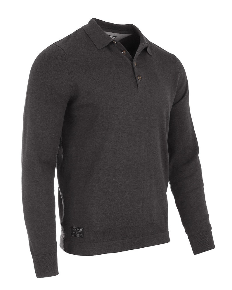 May include: A charcoal gray long-sleeved polo shirt with a button-up collar and a small logo patch on the bottom left side.