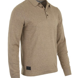May include: A long-sleeved, light brown knitted polo shirt with a button-up collar and a small black patch label with the text "Dingo" on the bottom right side.