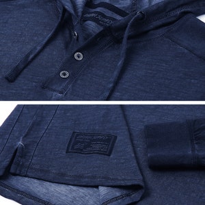 May include: A dark blue long-sleeved hooded shirt with a button-up front and a small label that reads "DRIFT SUPPLY" on the left side of the shirt.