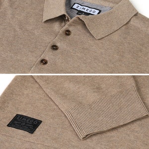 May include: A beige knitted polo shirt with a button-up collar and a brown button closure. The shirt has a ZIMEGO label on the collar and a ZIMEGO patch on the sleeve.