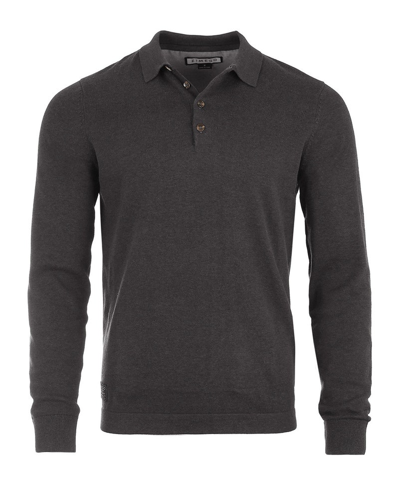 May include: A charcoal gray long-sleeved polo shirt with a button-up collar and a small logo on the left sleeve.