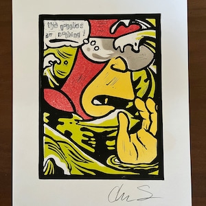 May include: A yellow and red linocut print of a cartoon character with a speech bubble that says "The goggles do nothing!" The character is wearing goggles and has a surprised expression. The print is signed "Chris S."