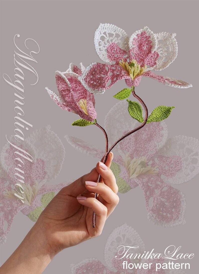 May include: A handmade crochet magnolia flower with pink petals and white lace edges. The flower has green leaves and a brown stem. The text "Magnolia Flower" and "Tanitka Lace flower pattern" are also visible.