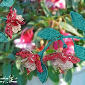 May include: A crochet fuchsia flower branch featuring three detailed blossoms with red petals, beige centers, and long stamens, connected by teal green stems and textured leaves. The text Tanitka Lace flower pattern is visible in the corner.