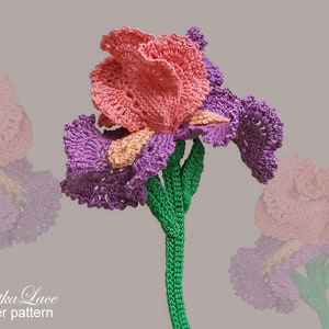 May include: A handmade crochet iris flower in shades of pink, purple, and peach. The flower has a green stem and is set against a neutral background. The text "Tanitka Lace flower pattern" is visible.