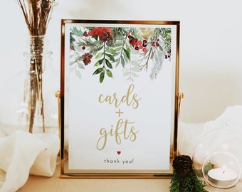 May include: A gold framed sign with a watercolor floral design in shades of red, green, and white. The sign says "cards + gifts thank you!" with a small red heart.