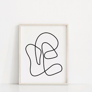 May include: A black and white line drawing of an abstract shape in a white frame.