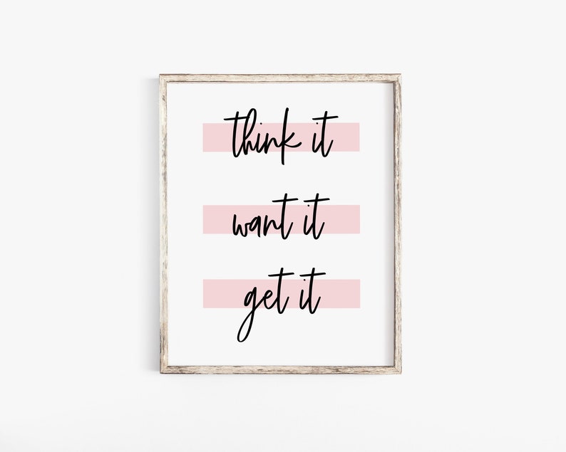 May include: A white framed print with the text "think it, want it, get it" in black script. Each line of text is underlined with a pink stripe.