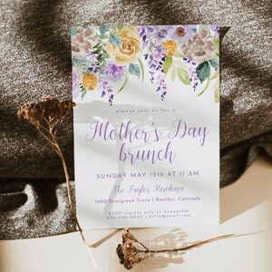 May include: A watercolor floral design invitation for a Mother's Day brunch. The invitation features a purple and yellow floral design with the text "Mother's Day brunch" in purple script. The text below reads "Sunday May 12th at 11 AM, The Taylor Residence, 1600 Evergreen Trace | Boulder, Colorado. RSVP regrets only to Annabella 000-000-0000 | hello@email.com"