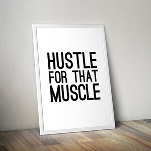 May include: White framed motivational poster with black text that reads "Hustle for that Muscle".