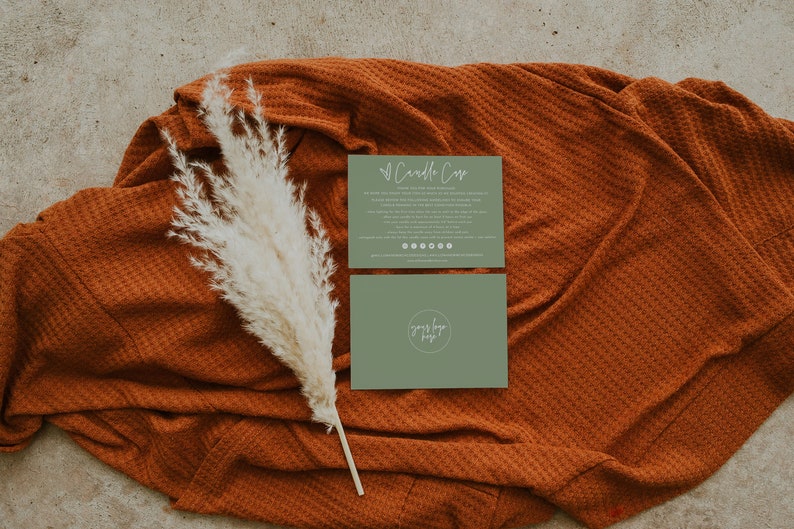 May include: Two green cards on a brown textured surface. The top card has the text "Candle Care" and instructions for candle care. The bottom card has the text "yours truly" in a circle.