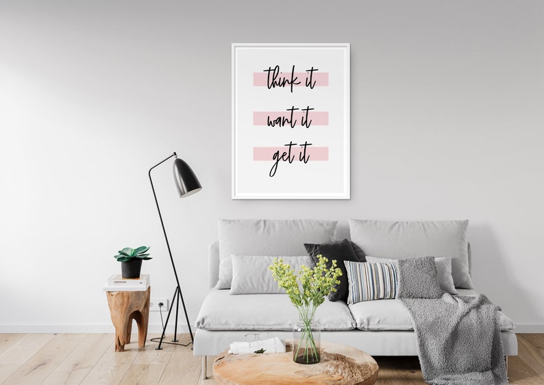 May include: A white framed print with the text "think it, want it, get it" in black script. The text is underlined with a pink stripe.