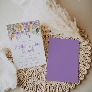 May include: A purple and white invitation card with a watercolor floral design. The text on the card reads "Please join us for a Mother's Day brunch, Sunday May 12th at 11 AM, The Tayler Residence, 1600 Evergreen Trace | Boulder, Colorado, RSVP regrets only to Avabella, 000-000-0000 | hello@email.com".