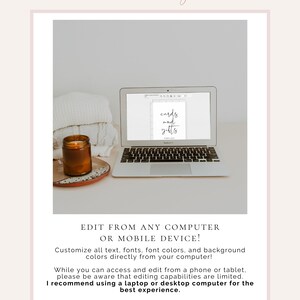 May include: A laptop computer screen displaying a digital design for a sign that reads "cards and gifts". The laptop is on a white surface with a brown candle and a white blanket.