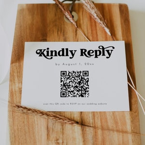 May include: A white card with black text that reads "Kindly Reply by August 1, 20xx". A black and white QR code is below the text with the caption "scan this QR code to RSVP on our wedding website".