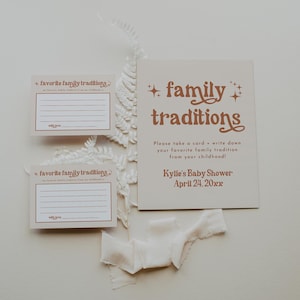 A neutral-toned baby shower sign with coordinating tradition cards invites guests to share their childhood memories. Set against soft cream fabrics and dried botanicals, this display creates a meaningful moment.