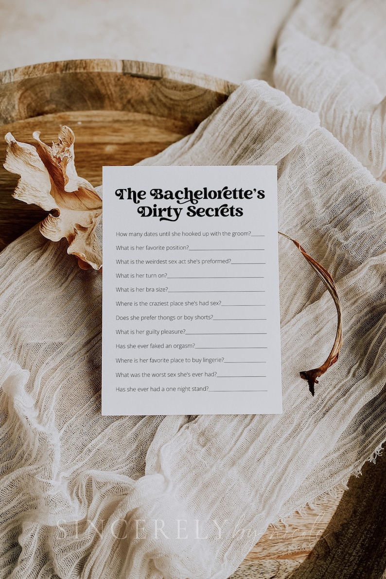 A bachelorette party game card featuring "The Bachelorette’s Dirty Secrets" on textured rust-colored fabric with pampas grass. A bold and entertaining game for a memorable night.