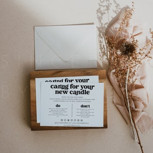 May include: A white card with black text that reads "caring for your new candle". The card is on a wooden surface and includes instructions on how to care for a candle. The text includes "do" and "don't" lists with instructions on how to properly care for a candle.