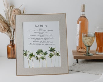 May include: A framed bar menu with a beige linen background and a watercolor illustration of palm trees. The menu lists beer, wine, spirits, and a signature cocktail. The text reads "Bar Menu", "Beer", "Wine", "Spirits", "Signature Cocktail", "Raspberry Rose Gin Tonic", "gin, tonic water, fresh lime juice, fresh raspberries, garnished with dried rose petals", and "Sincerely by Nicole, Designs for Every Lifestyle".