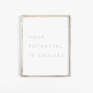 Puede incluir: Una impresi&oacute;n enmarcada con el texto "YOUR POTENTIAL IS ENDLESS" en una fuente simple y minimalista.