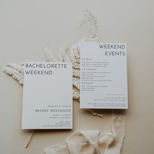 Simple bachelorette weekend invitation and event schedule card displayed with natural dried fern and soft fabric. The design highlights a modern, minimalist style for a celebration.