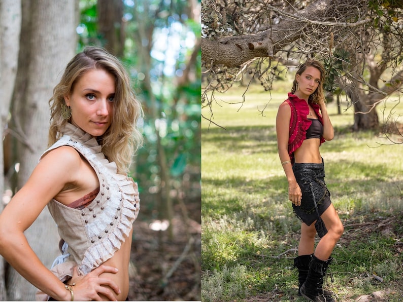 May include: A beige sleeveless vest with ruffled trim, metal studs, and lace detailing, paired with a black bandeau top and a black skirt with side ties and fringe accents, worn with black mid-calf boots and gold-toned dangling earrings.