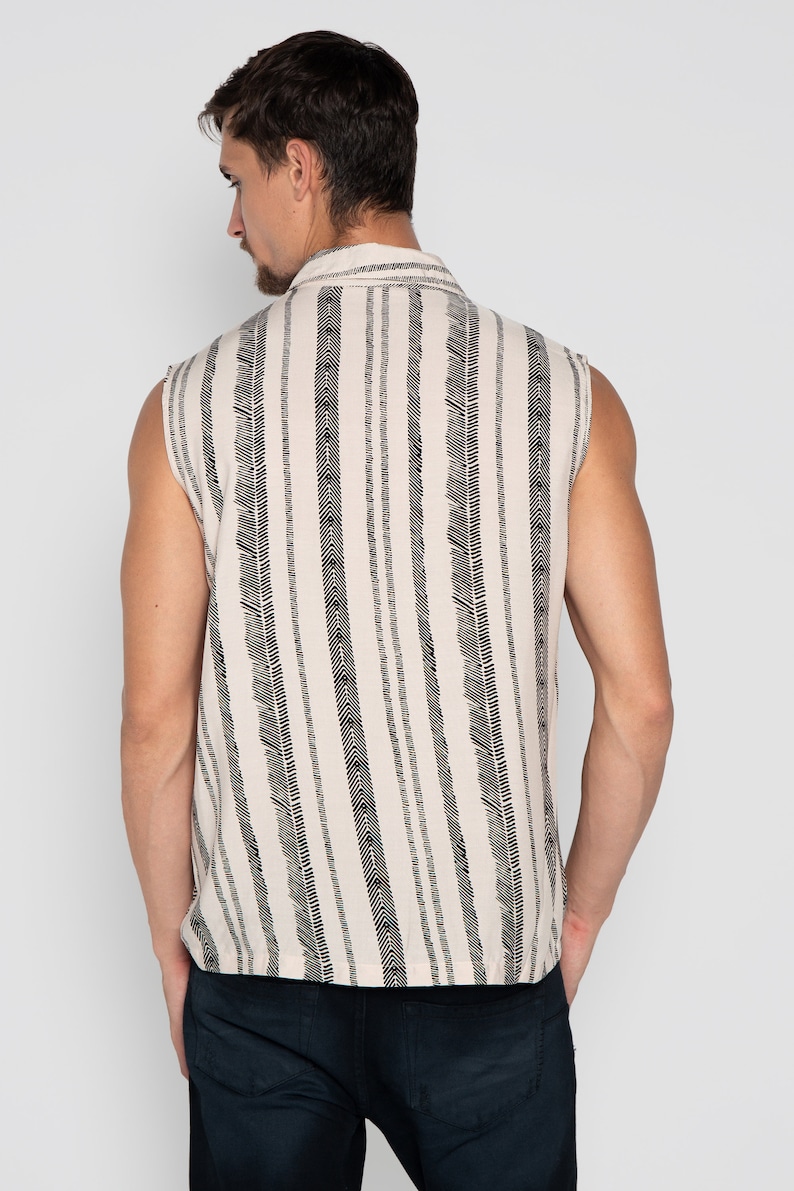 May include: A sleeveless shirt with a white background and black vertical stripes. The stripes are made up of small, repeating patterns.