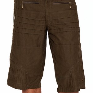 May include: Olive green cargo shorts with multiple pockets and a black studded belt with a brass buckle.