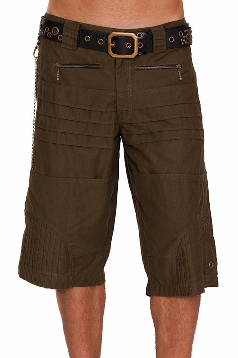 May include: Olive green cargo shorts with multiple pockets and a black studded belt with a brass buckle.