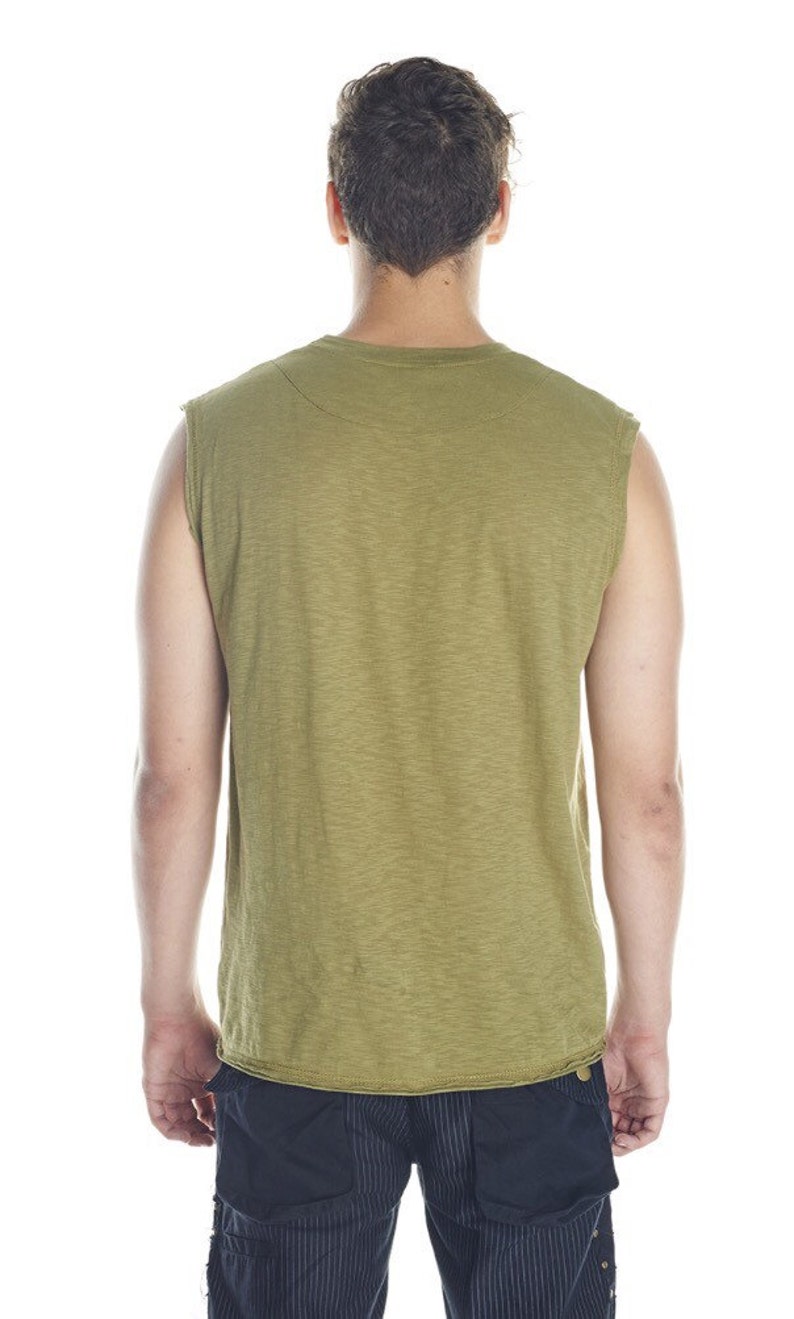 May include: A sleeveless shirt in a light green color with a textured fabric. The shirt has a crew neck and a relaxed fit.