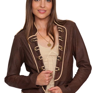 May include: A brown leather jacket with a tan trim and gold buttons. The jacket has a stand-up collar and a fitted silhouette.