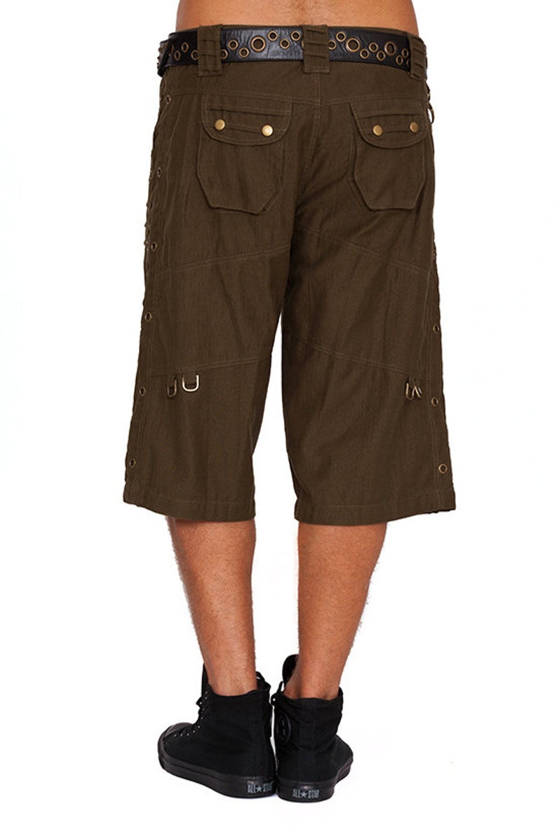 May include: Dark green cargo shorts with multiple pockets and metal accents. The shorts have a black belt with metal eyelets.