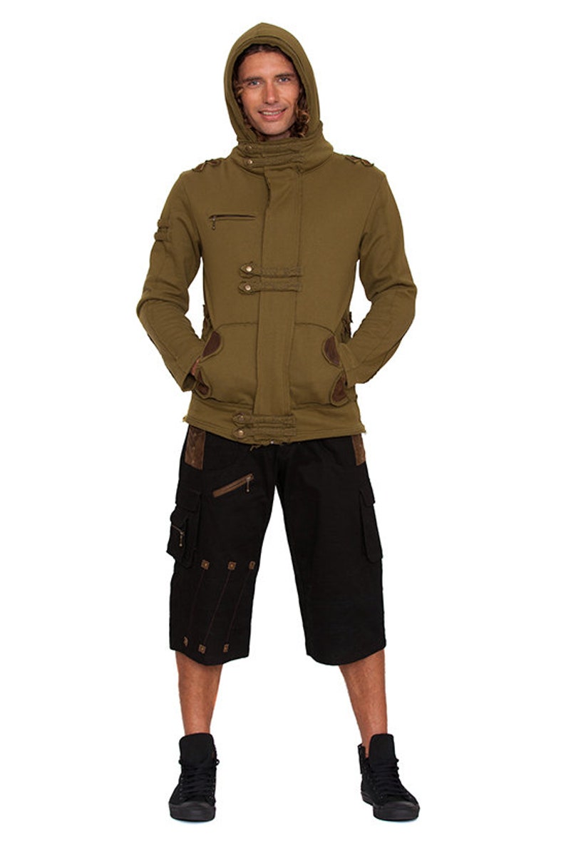 May include: An olive green hooded jacket with brown accents, paired with black cargo shorts and black high-top sneakers. The jacket features a zipper pocket and decorative buttons. The shorts have multiple pockets and decorative stitching.