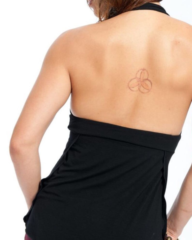 May include: Black halter top with a low back and a thin strap. The top is made of a soft, stretchy fabric and has a relaxed fit.