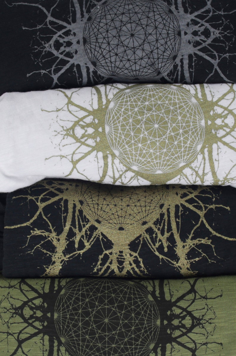 May include: Four folded t-shirts with a geometric pattern and a tree-like design in black, white, and green.