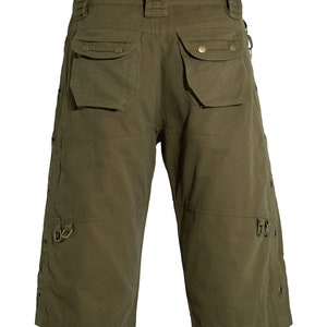 May include: Olive green cargo shorts with multiple pockets and metal accents.