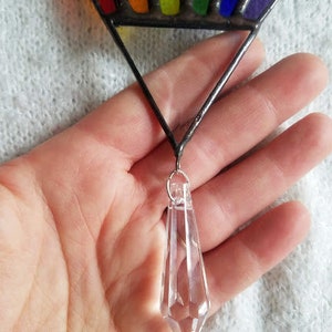 May include: A rainbow stained glass suncatcher with a clear crystal prism hanging from the bottom.