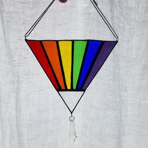 May include: A rainbow stained glass suncatcher in the shape of a diamond with a crystal prism hanging from the bottom.