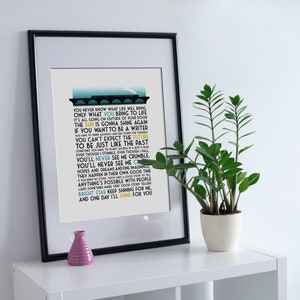 May include: A framed print with a black frame and a white background. The print features a blue and yellow graphic of a train with lyrics from the song "Bright Star" by Train. The lyrics include the words "You never know what life will bring, only what you bring to life."