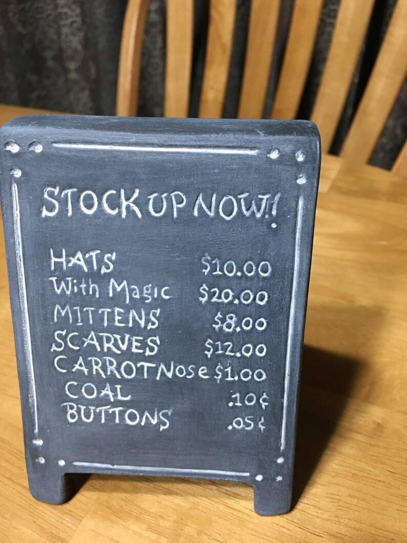 Snowman Outfitters Sign