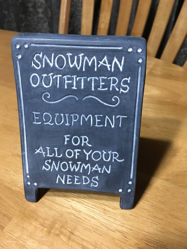 Snowman Outfitters Sign