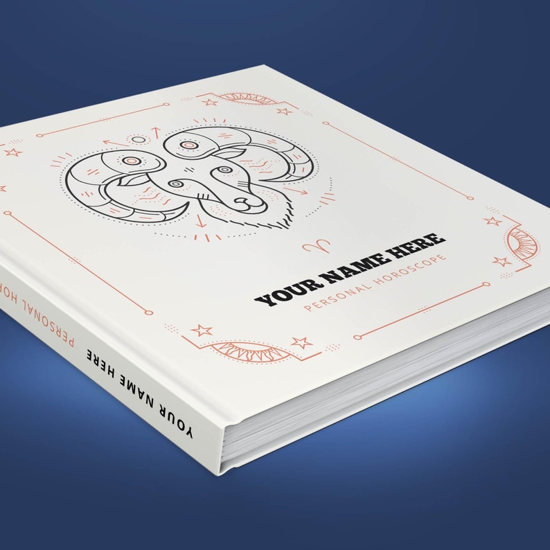 May include: A white book with a red and black illustration of an astrological ram symbol. The text "YOUR NAME HERE PERSONAL HOROSCOPE" is printed on the cover.
