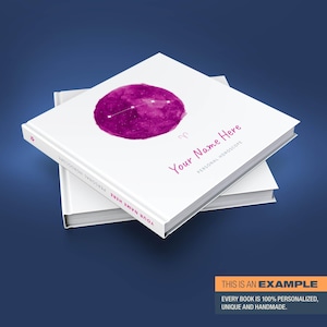 May include: A personalized horoscope book with a pink watercolor illustration of the Aries constellation. The book cover features the text "Your Name Here" and "Personal Horoscope".