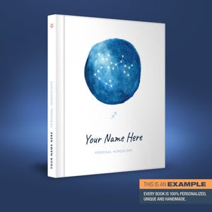 May include: A white book cover featuring a blue watercolour illustration of the Sagittarius constellation. The text "Your Name Here" and "Personal Horoscope" is printed on the cover.