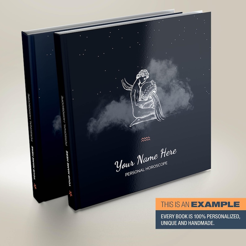 May include: A dark blue personalised horoscope book with a white illustration of the Aquarius zodiac sign. The book has the text "Your Name Here" and "Personal Horoscope" printed on the cover.